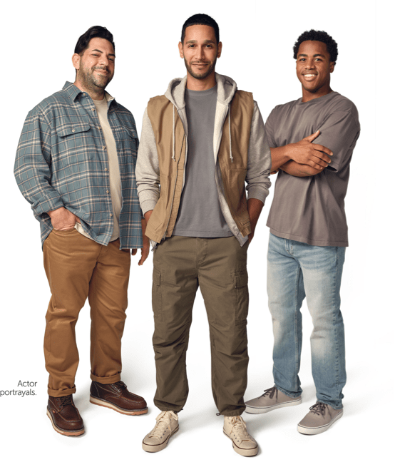 Three individuals standing and smiling.