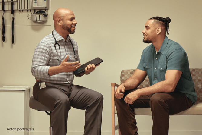 Two men sitting and discussing HIV PrEP.